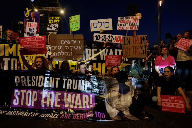Demonstrators hold a banner featuring an image of U.S. President Donald Trump, during a protest to demand the immediate release of all hostages held in Gaza.