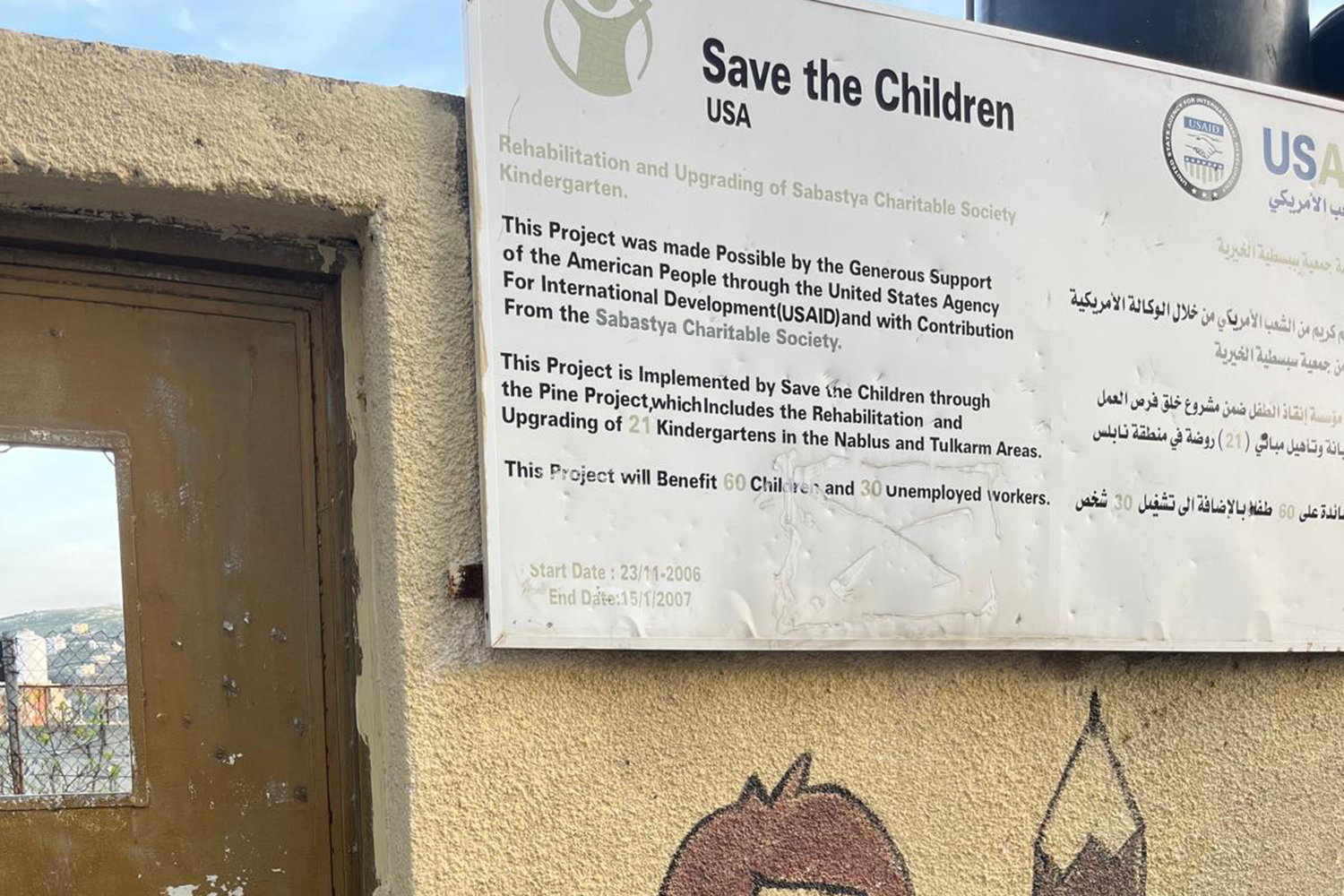Bullet hole-ridden Save The Childrennursery sign in Sebastia