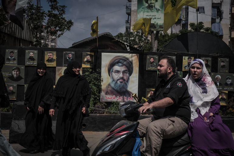 A busy street in Hay El Selom, decorated by posters of Hezbollah martyrs, including the late leader of the organisation, Sayyed Hassan Nasrallah, where Fatima and her two sons used to live before their home was destroyed by an Israeli airstrike in 2024 [João Sousa/media]