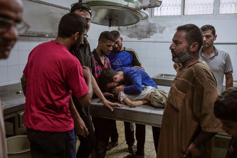 Palestinians mourn a child killed in an Israeli military airstrike on Gaza, at the morgue of Shifa Hospital in Gaza City, Saturday, July 12, 2025. (AP Photo/Jehad Alshrafi)