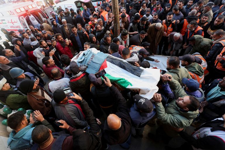 Mourners attend the funeral of Palestinian journalist Ahmed Al-Louh