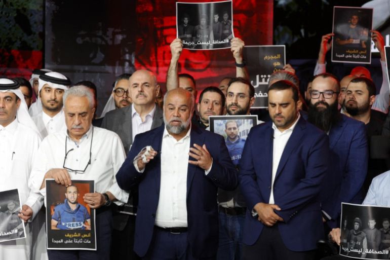 Wael Al-Dahdouh (C), media's bureau chief in Gaza, delivers a statement during a moment of silence to honour five of media staff members, killed in an overnight Israeli strike in Gaza City, at the networks' headquarters in Doha on August 11, 2025. [Karim Jaafar/AFP]