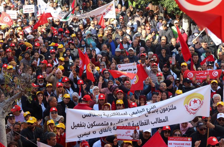 Supporters of the Tunisian General Labour Union (UGTT), carry banners and flags during a protest against President Kais Saied's policies, accusing him of trying to stifle basic freedoms including union rights, in Sfax, Tunisia February 18
