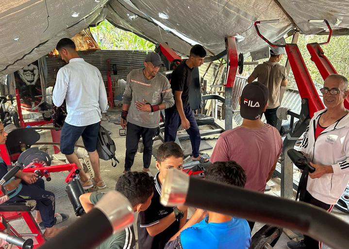Coach and athletes training in the tent gym in al Mawasi.