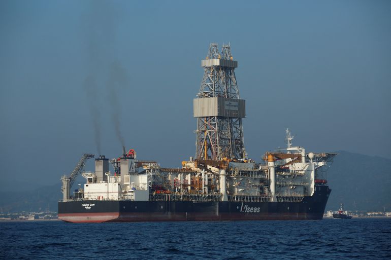 a large ship with smoke rising from it