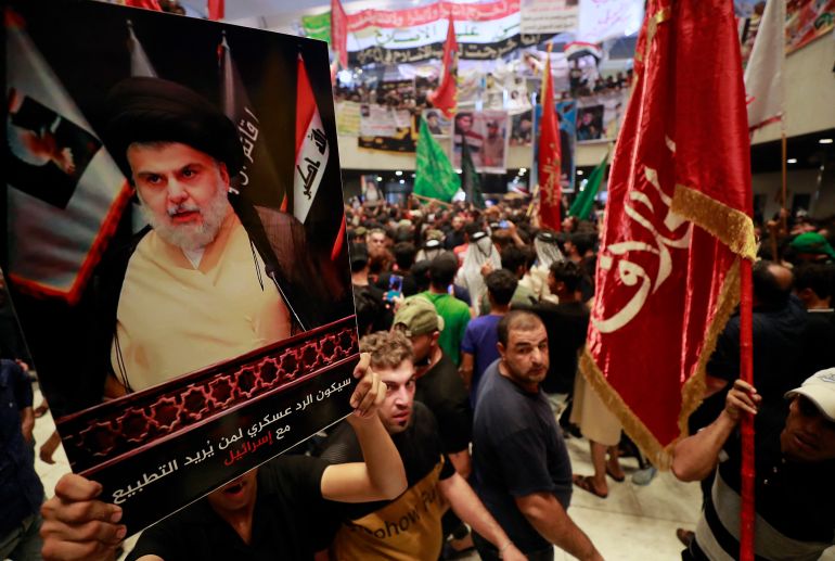 (FILES) In this file photo taken on August 2, 2022, supporters of Iraqi cleric Moqtada Sadr (image), protest against a rival bloc's nomination for prime minister, in the capital Baghdad's high-security Green Zone. - The movement led by firebrand cleric Moqtada Sadr announced today its refusal to be part of the upcoming government set to be formed by Mohammad Shia al-Sudani. (Photo by AHMAD AL-RUBAYE / AFP)