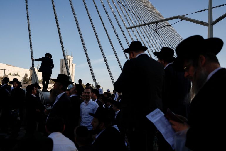 Ultra-Orthodox Jewish men gather on the Ultra-Orthodox Jewish men gather on the Chords Bridge during the "Million Man" protest against Israeli military conscription in Jerusalem [Ammar Awad/Reuters]