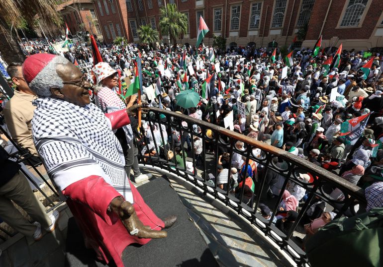 Demonstrators hold Palestinian flags and placards as they walk past a statue of the late Nobel Peace Laureate, Archbishop Desmond Tutu during a protest to show support to Palestinians in the Gaza Strip, in Cape Town, South Africa, September 27, 2025.