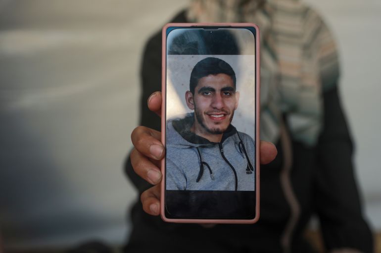 A mobile phone shows an image of Israa's brother Diaa