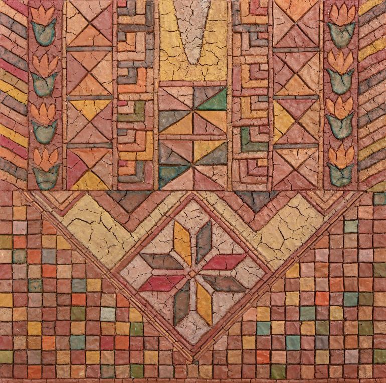 An art piece with geometric designs rendered on a wood panel, the mud is in different colours, making a mosaic