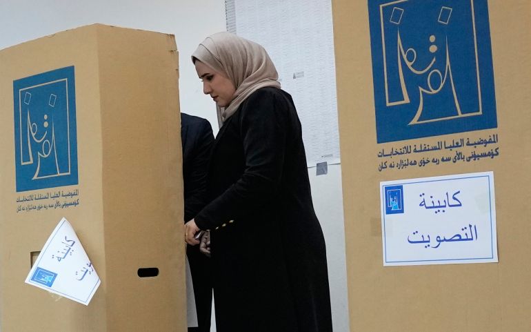 An Iraqi woman casts her vote during the parliamentary election at a polling centre in Baghdad, Iraq on November 11, 2025.