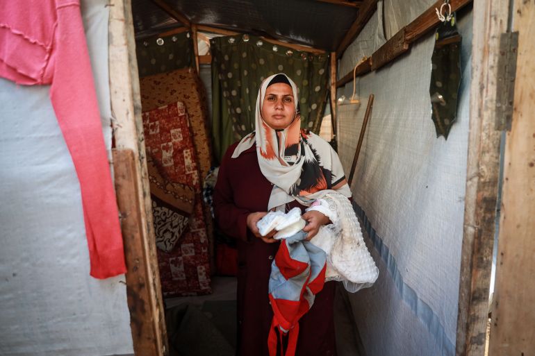 A woman holds her belongings