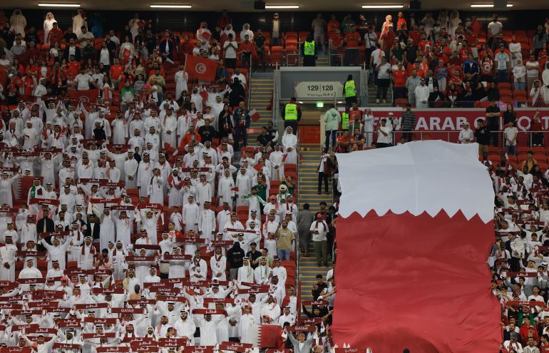 Soccer Football - FIFA Arab Cup - Qatar 2025 - Group A - Qatar v Tunisia - Al Bayt Stadium, Al Khor, Qatar - December 7, 2025 Qatar fans with a giant banner inside the stadium before the match REUTERS/Thaier Al-Sudani