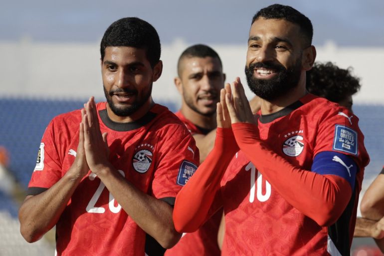 Egypt's forward #20 Ibrahim Adel celebrates with forward #10 Mohamed Salah.