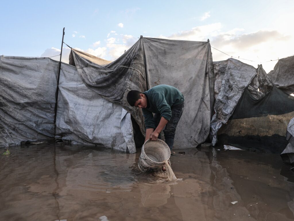 Palestinians suffer flooded tents and debris as cold and rain lash Gaza Palestinians suffer flooded tents and debris as cold and rain lash Gaza