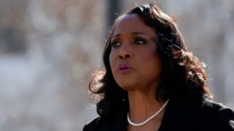 REUTERS/Nathan Howard/File Photo Lisa good is turned partially with a blurred grey background. She is wearing pearls, a black suit and appears to be speaking outside