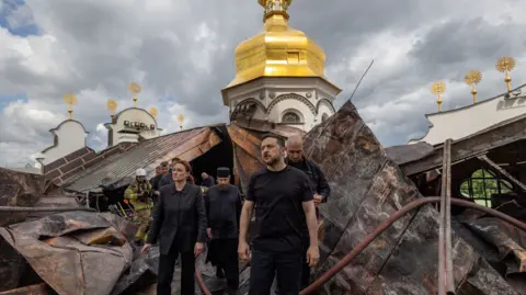 Reuters Ukraine's President Volodymyr Zelenskiy and Ukrainian Prime Minister Yulia Svyrydenko visit the Dormition Cathedral of the Kyiv Pechersk Lavra, which was hit during Russian missile and drone strikes, amid Russia's attack on Ukraine, in Kyiv, Ukraine June 15, 2026. 
