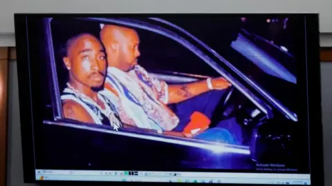 Reuters A 1996 photo of rapper Tupac Shakur (L) and Marion "Suge" Knight displayed during the murder trial
