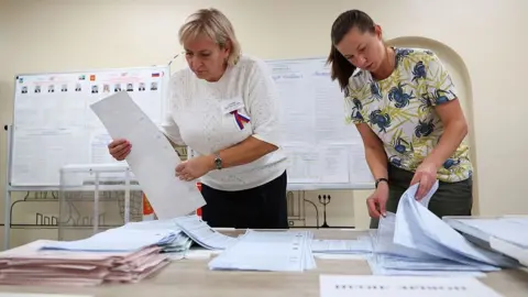 Emil Leegunov/Anadolu via Getty Images Members of an electoral commission count votes after polls close on the final day of elections to Russia's ninth State Duma, the lower house of parliament