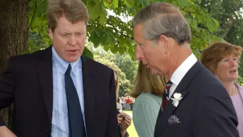 PA Media Earl Spencer and the then Prince Charles opening a memorial to Diana in 2004