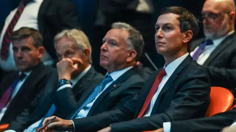 Getty Images Tony Blair, Steve Witkoff, and Jared Kushner watching a presentation during a Board of Peace briefing 