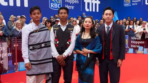 George Pimentel From right: Theja Rio poses with Nancy Nisa Beso, the film's producer, and actors Anglong Konyak (as the village chief, Anghba) and Sobino Rengma (as his son Amao)