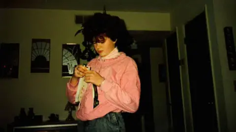 Christa Pike Christa Pike pictured as a teenager. She has curly brown hair and is wearing a pink top and jeans. She is looking down at something in her hands - the room is dark.