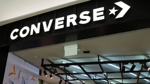 Getty Images The Converse name is seen on a storefront at an airport in Singapore earlier this month