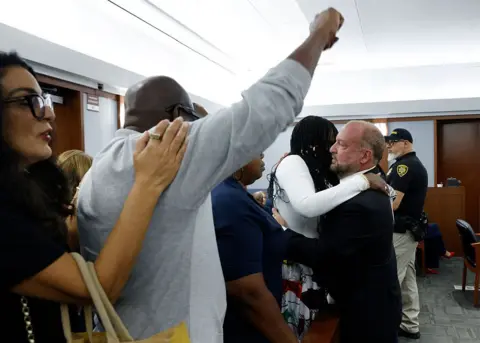Getty Images A man pumps his fist in the air as friends and family of Tupac Shakur celebrate a guilty verdict in the trial of Duane "Keffe D" Davis 