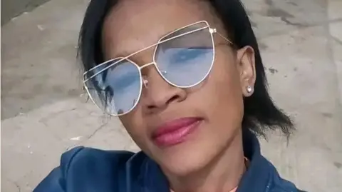 Dineo Motapane A selfie of Dineo Motapane, wearing sunglasses and a blue jacket