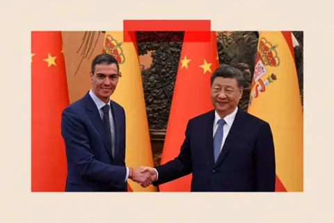 Reuters Pedro Sanchez and Xi Jingping shake hands with their country flags behind them. Both men are dressed in dark suits