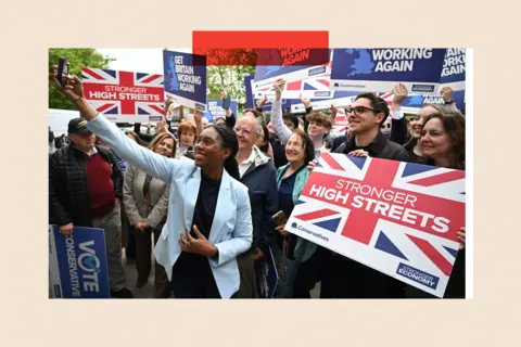 Getty Kemi Badenoch campaigning with a group of supporters