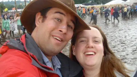 Supplied A man and a woman smiling in a muddy field