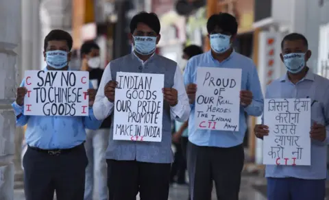 Bloomberg via Getty Images Indian traders in Delhi wearing masks hold placards during a silent protest against China and Chinese products in 2020, after 20 Indian soldiers were killed in the skirmish with Chinese troops in the Galwan Valley. 

