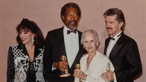 Getty Images (L-R) English actress actress Joan Collins, American actor Morgan Freeman, English and American actress Jessica Tandy and American actor Tom Skerritt in the press room during the 47th Golden Globe Awards at the Beverly Hilton Hotel in Beverly Hills, California, 20th January 1990. 