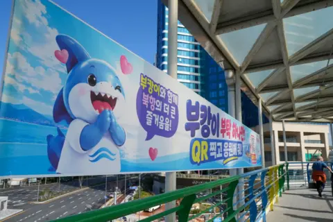 Hosu Lee/BBC A poster of showing a shark meant to represent Bukangi.