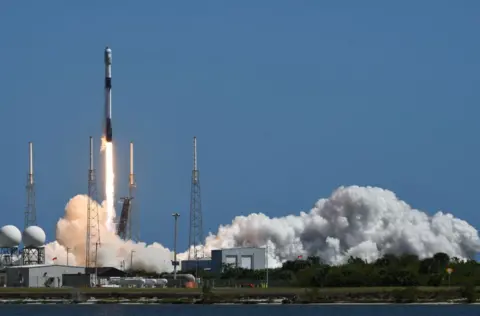 Paul Hennessy/ Getty Images A rocket taking off, with heavy smoke around the base.