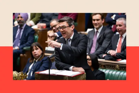 PA Media Andy Burnham in a black suit speaking at parliament and doing a pointing motion with his hand as he addresses MPs.