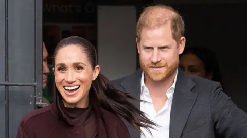 Mark Cuthbert/Getty Images  Meghan, Duchess of Sussex and Prince Harry, Duke of Sussex outside The Community Recording Studio