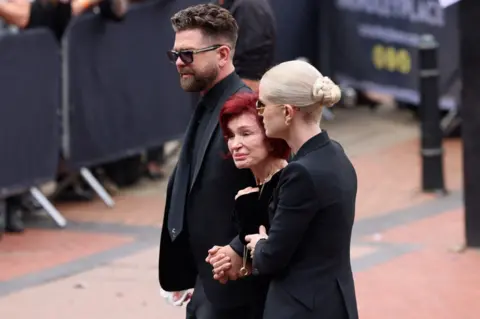 Reuters Jack, Sharon and Kelly Osbourne at Ozzy's funeral in Birmingham