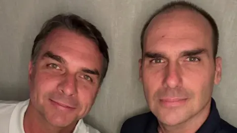 Eduardo Bolsonaro/Instagram/Reuters Flavio Bolsonaro  and his brother, Eduardo Bolsonaro, smile at the camera as they pose at an unidentified location, in this picture obtained from social media and released on October 28, 2026.