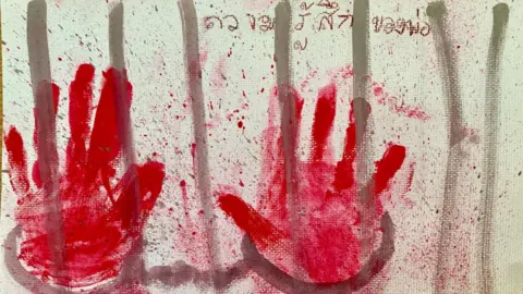 Arnon Nampa's family A painting of a pair of handcuffed hands on prison bars by Arnon's daughter, with the words, "my dad's feelings" written above them, in Thai.
