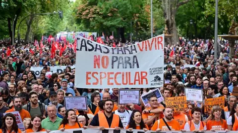 NurPhoto via Getty Images Thousands of people, many wearing orange, participate in a demonstration in Madrid demanding access to affordable housing and protesting against the housing crisis, rising rents, and evictions. 