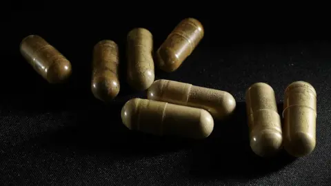 Getty Images Kratom pills on a black back drop