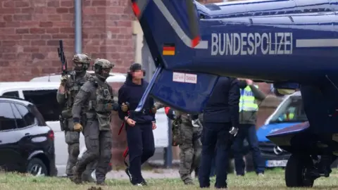 Reuters Police escorts Serhii K. to a helicopter following a hearing with the German Federal Public Prosecutor, after Italy's top court approved the handover to Germany of the Ukrainian man, suspected of coordinating the 2022 sabotage of the Nord Stream gas pipeline, in Karlsruhe, German
