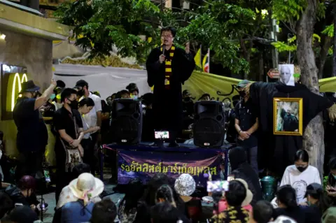 Reuters Arnon Nampa dressed as Harry Potter gives a speech at the protest in August 2020.