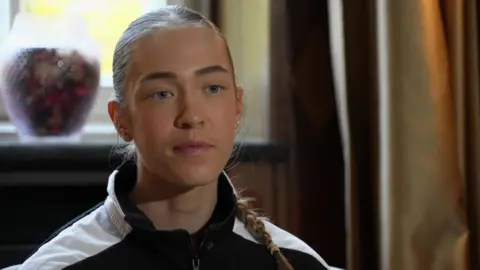 A young woman with hair in a pigtail