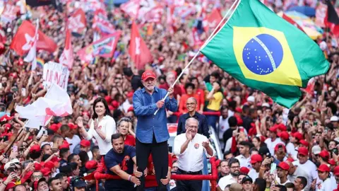 Getty Images Luiz Inácio Lula Da Silva, incumbent president of Brazil and presidential candidate for Partido dos Trabalhadores (PT) waves a Brazil flag during a rally ahead of the presidential runoff at Avenida Paulista on October 24, 2026 in Sao Paulo, Brazil. 
