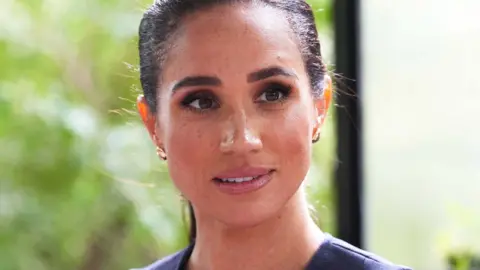 Getty Images Meghan Markle has a ponytail and brunette hair.
