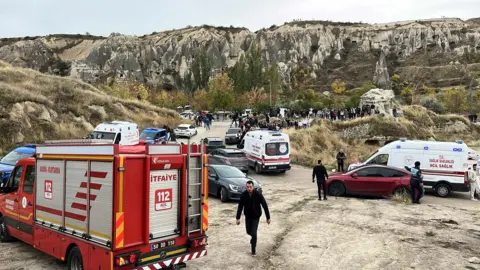 Reuters Fire truck and ambulances are parked near the scene